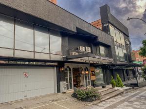 a black building on a city street at Orbe Hotel Medellín in Medellín