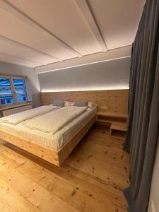a bedroom with a large bed in a room at ADAM Suites - Brixen Card included in Bressanone