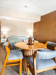 a room with a table and chairs and a bed at Playasol Las Hadas Beach in Manzanillo +27 photos