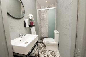 a bathroom with a sink and a toilet and a mirror at LİME BOZCAADA in Bozcaada +75 photos
