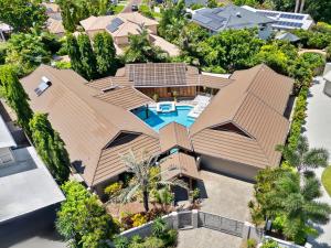 an aerial view of a house with a swimming pool at Three Corners Of Paradise in Clifton Beach