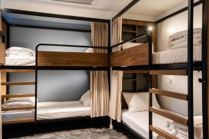 a group of bunk beds in a room at Haka House Auckland City in Auckland