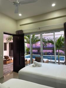 a bedroom with a bed and a view of a pool at Casa Arizona in Brisas de Zicatela +115 photos