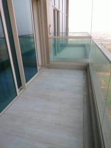 an empty balcony in a building with glass floors at Atithi Dream Studios in Gurgaon