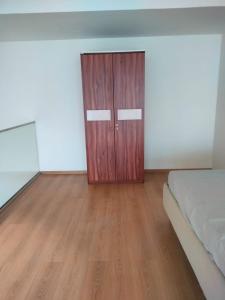a bedroom with a wooden door and a bed at Atithi Dream Studios in Gurgaon +7 photos