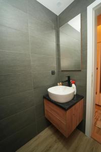 un baño con lavabo y espejo en Residence Hill - Planinski Kutak, en Kopaonik