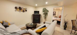 a living room with a couch and a fireplace at Holiday Hideout Basement Unit in Pickering