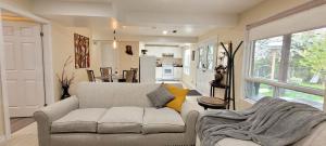 a living room with a couch and a kitchen at Holiday Hideout Basement Unit in Pickering