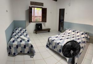 En eller flere senge i et værelse på Casa Vovó Maria - De frente para o de Japaratinga + 15 billeder