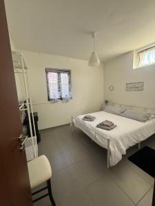 a bedroom with a bed and a chair in it at La casa di Palmira in Selcetta