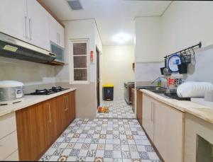 a kitchen with a tiled floor in a kitchen at De Lavender Villa 1 in Citaringgul 1 +6 photos