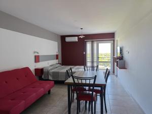 a living room with a couch and a table and a bed at Vanguardia Suites in San Juan