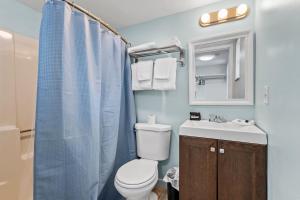 a bathroom with a toilet and a sink at Oceanfront Inn Room #18- Ocean View Balcony 2 Full Beds in Fort Pierce