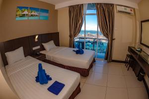 Letto o letti in una camera di Wave View Hotel