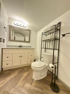 a white bathroom with a toilet and a sink at Cozy lake house in Nassau +29 photos