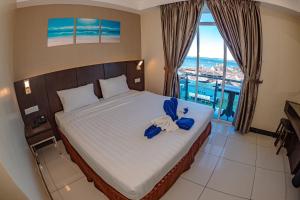 Letto o letti in una camera di Wave View Hotel