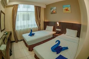 Letto o letti in una camera di Wave View Hotel