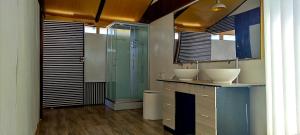 a bathroom with two sinks and a glass shower at Los Uros vista Ciudad Puno in Puno +72 photos