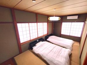 Postel nebo postele na pokoji v ubytování ビーチまで徒歩5分 BBQ無料 7名迄OK 戸建て貸切宿 Bignet villa