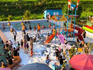 a group of people in the water at a water park at Villa Kayu Razka in Indarung