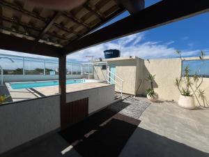 a view from the balcony of a house with a swimming pool at Casa temporada Cabo Frio Casa pôr do Sol in Cabo Frio