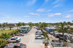 a parking lot with cars parked in a parking lot at Oceanfront Inn Room #21- Ocean View Balcony King Bed in Fort Pierce