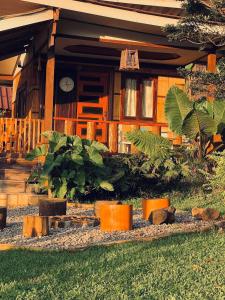 a house with a clock on the front of it at Rakkhao Inthanon sunset view in Ban Yang Di Pha Mop +11 photos