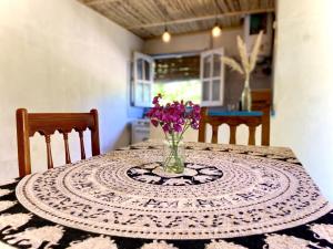 a table with a vase of flowers on top of it at Refugio agroecológico en San Rafael in San Rafael