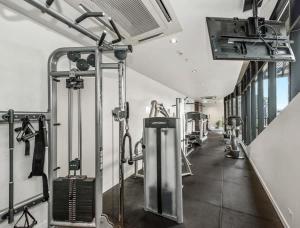 a gym with several treadmills and machines at Neo200 - Sophisticated 2bed CBD Apt with parking in Melbourne