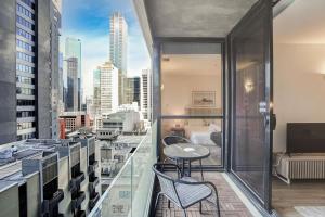 a balcony with a view of a city at Neo200 - Sophisticated 2bed CBD Apt with parking in Melbourne