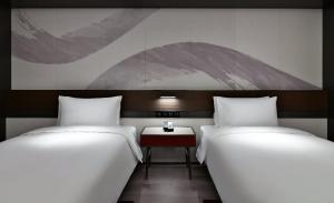 Voodi või voodid majutusasutuse JOYA Hangzhou Qianjiang New Town toas