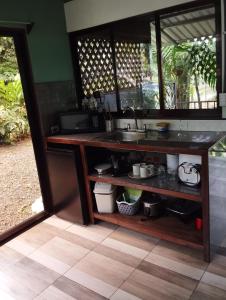 a kitchen with a sink and a counter at Breezes Ecolodge in San Ramón +36 photos