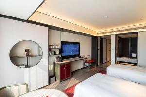 Voodi või voodid majutusasutuse JOYA Hangzhou Qianjiang New Town toas