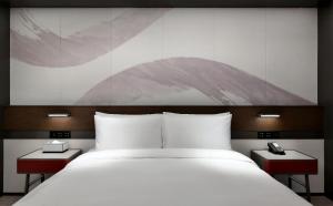 Voodi või voodid majutusasutuse JOYA Hangzhou Qianjiang New Town toas