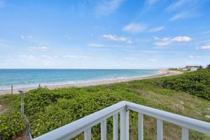 a balcony with a view of the beach at Oceanfront Inn Room #25- Ocean View Balcony King Bed in Fort Pierce