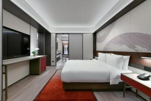 Voodi või voodid majutusasutuse JOYA Hangzhou Qianjiang New Town toas
