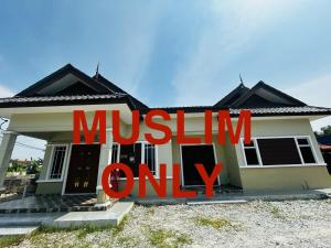 a house with a sign that reads muslin only at Ariana Homestay in Sekincan