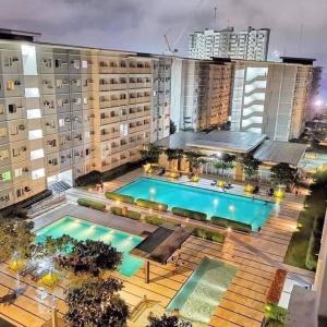 an overhead view of a building with a swimming pool at 1-bedroom Condo Unit with PS5, Netflix & Pool near SM Fairview in Manila +1 photo