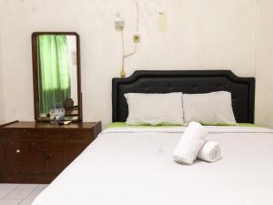 a bedroom with a bed with two towels on it at Prayogo Style Inn Prawirotaman in Yogyakarta +42 photos