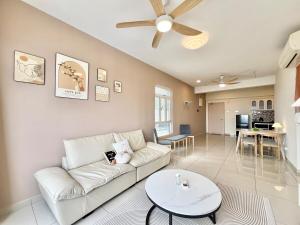 a living room with a white couch and a table at Perling Muji 3 Bedrooms Suites 6 pax Paradigm Mall in Johor Bahru