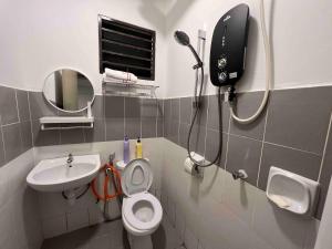 a bathroom with a shower and a toilet and a sink at Cosy Pinewood House 5 Pax- Family friendly, Wifi in Kajang