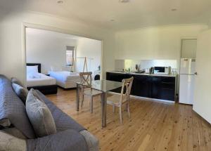 a living room with a table and a couch at Studio house Unit in Dundas Valley in Sydney