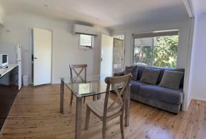 a living room with a table and a couch at Studio house Unit in Dundas Valley in Sydney