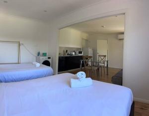 a hotel room with two beds and a kitchen at Studio house Unit in Dundas Valley in Sydney