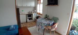 a small kitchen with a table in a room at Studio à la mer in Criel-sur-Mer