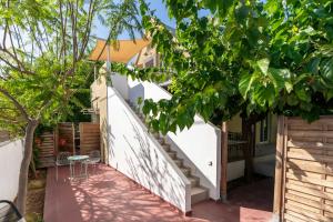 a staircase leading up to a house with trees at Seaside Glow in Schinias
