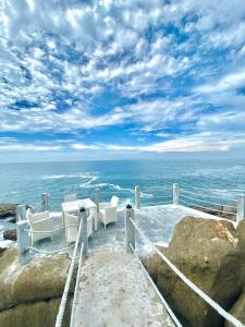 a table and chairs sitting on top of the ocean at Hotel Zeilan Sunset Point in Unawatuna