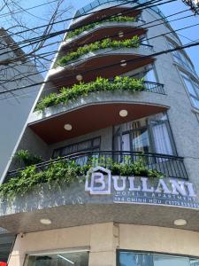 a building with a sign on the side of it at Bullani Hotel & Apartment in Da Nang