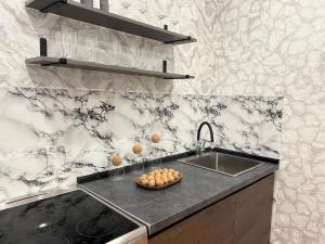 a kitchen with a sink and a counter top at Апартаменты стандарт in Pavlodar +1 photo