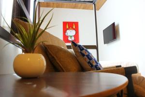 a dining room table with a vase on top of it at Chari3 in Hikone